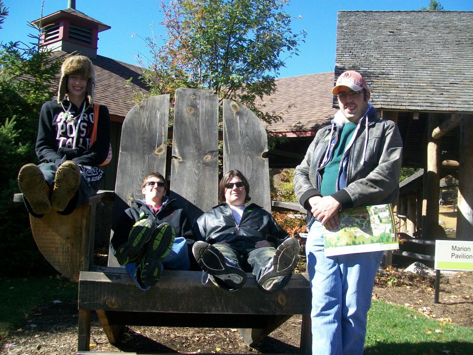 Photo of History Association members sitting in a giant Adirondack chair