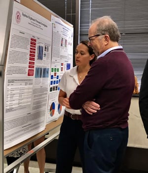 Kerri discusses her poster with a judge at the competition